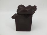 a chocolate sculpture of a man sitting on top of a box