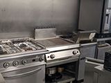 a large kitchen with a lot of stainless steel appliances