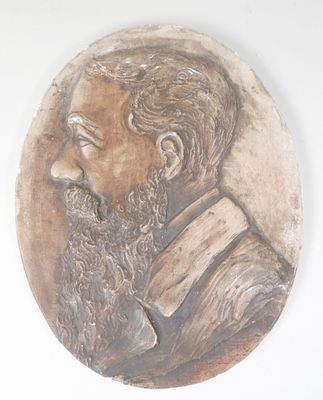 a plaque of a man with a beard on a wall