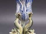 a blue and white vase with two birds on it