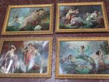 four framed paintings of women in a garden on a wall