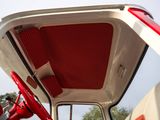 a close up of a red and white truck with its door open