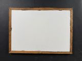 a painting on a black wall with a wooden frame