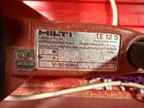 a close up of a red machine with wires attached to it