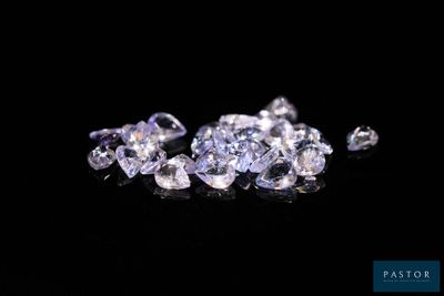 a close up of a bunch of diamonds on a black surface