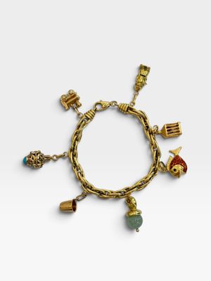 a gold bracelet with charms and charms on it