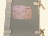 a small book with a ribbon on the cover