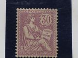 un timbre sur lequel figure l'image d'une femme assise