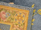 an image of a close up of a rug with a flower design on it