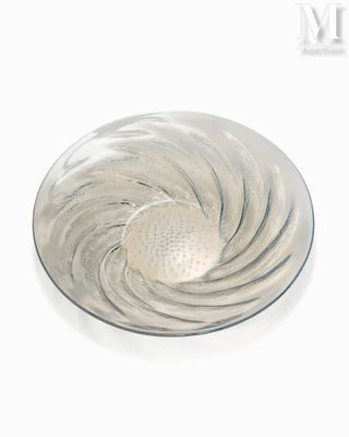 a glass plate with a silver swirl on it