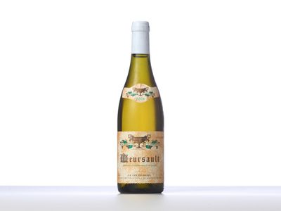 a bottle of white wine sitting on top of a table