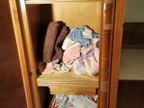 a closet full of clothes and towels in it