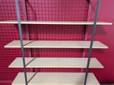 a shelf with four shelves on it in a room