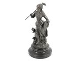 an image of a statue of a woman sitting on a rock with a sword