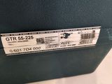 a black suitcase with a label on it sitting on a table