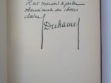 an open book with a handwriting on it sitting on top of a table