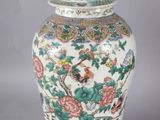 an image of a large chinese vase with a lid on a grey background
