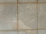 a picture of a man on a skateboard on a tiled wall