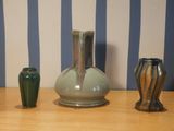 three vases sitting on a table next to each other