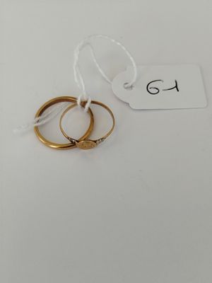 a pair of gold wedding rings on a white background