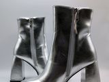 silver leather ankle boots with zippers on a white background