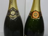 two bottles of champagne sitting next to each other on a table