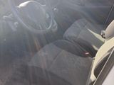 a car that is parked in the lot with the sun shining