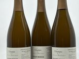 three bottles of wine sitting next to each other on a white surface