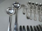 a lot of silver spoons and spoons on the table