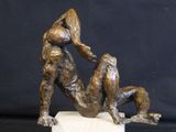 statue of a man wrestling a dog on a marble base