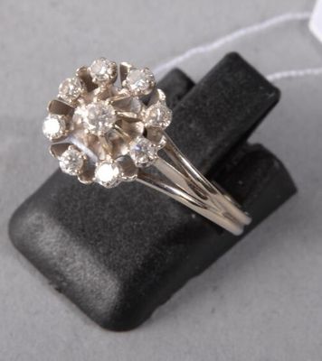 an image of a diamond ring sitting on top of a black piece of cloth