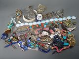 a pile of assorted jewelry sitting on a table