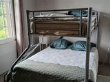 a bunk bed with a metal frame in a bedroom