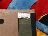 a pile of different colored rugs on the floor
