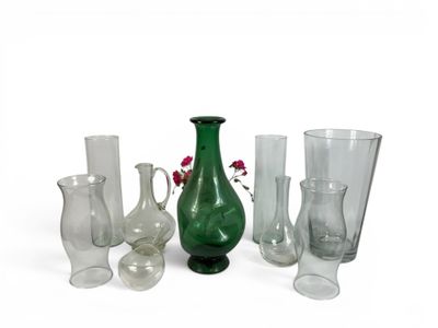 a lot of different glass vases and vases on the table