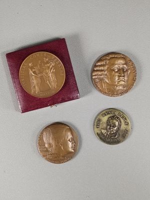three coins are sitting next to each other on a white surface