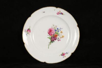 a white plate with flowers on it on a black background
