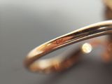 a close up of a gold ring with a diamond on it