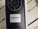 a black cell phone sitting on a table with a barcode on it
