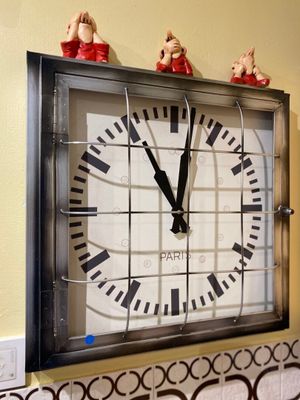 a clock that is hanging on the wall in the kitchen