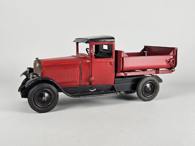 a red truck that is sitting on a white surface