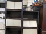 many shelves that are stacked up in a room
