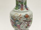 a white vase with a design on it sitting on a table