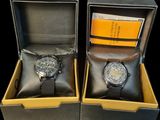 two watches sitting in a box on a table