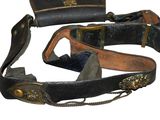 a belt that is attached to a purse on a white background