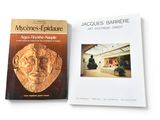 two books on a white surface with a picture of a man ' s face on the cover