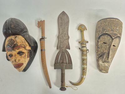 several different types of african masks are displayed on a white surface