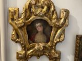 a gold frame with a picture of a woman in a red dress