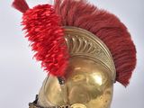 an image of a helmet with a red feather on top of it
