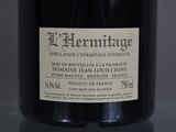 a bottle of wine sitting on a table with a label on it